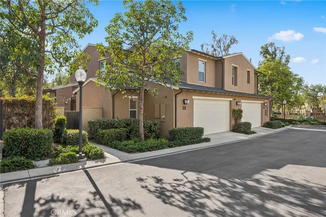 a front view of a house with a yard and a garage