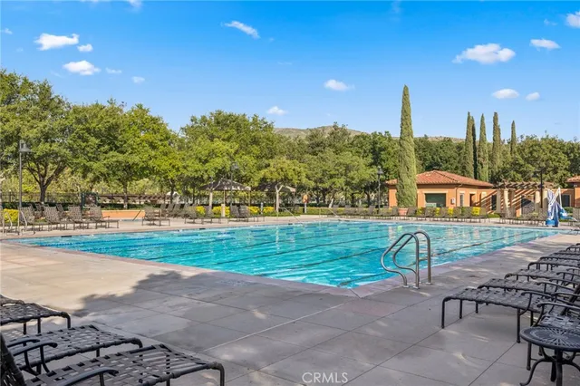 a view of a garden with a bench and trees