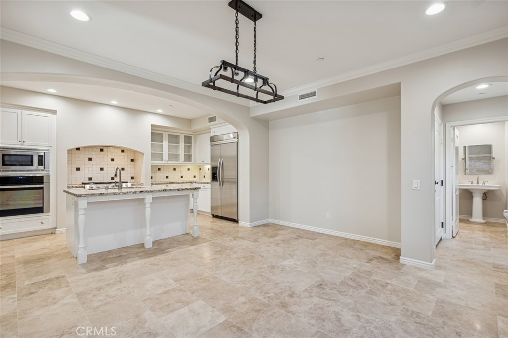 22 Ridge Valley Irvine, CA 92618 - Photo 9 of 37 a view of kitchen with a refrigerator sink cabinets and couch