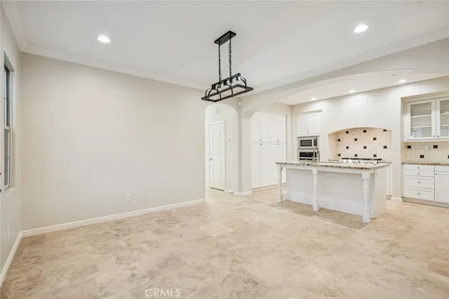 a view of kitchen with refrigerator and window