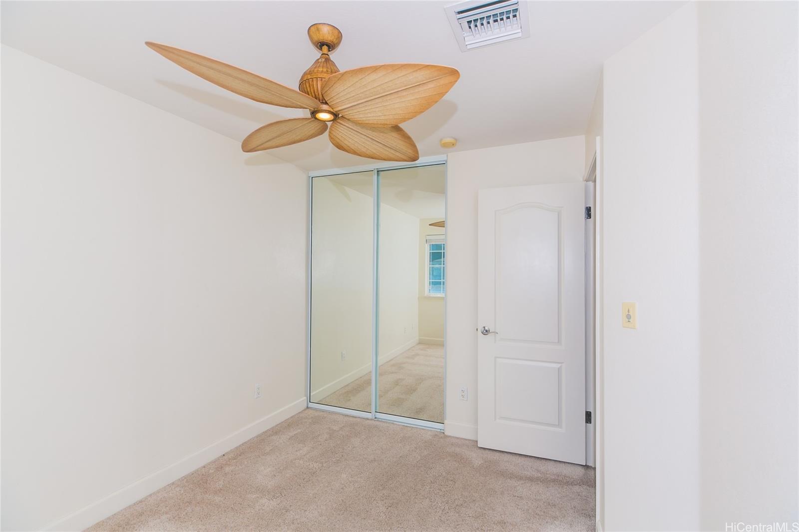 92-1516 Ali'inui Drive, Unit 1707 Kapolei, HI 96707 - Photo 10 of 23 a view of a chandelier fan and closet