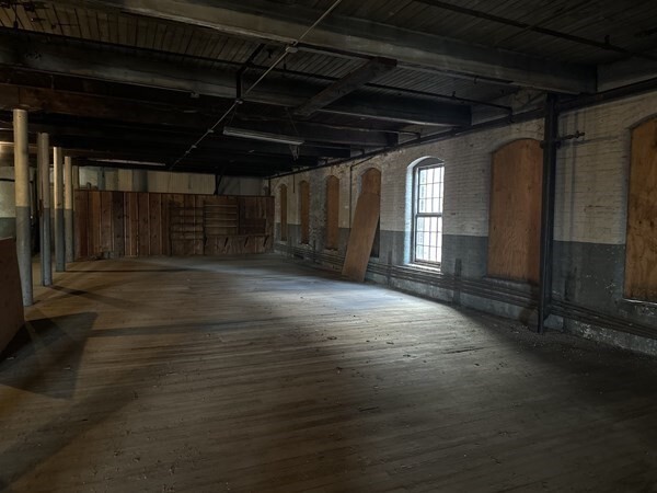 130 Middle Water Street Holyoke, MA 01040 - Photo 4 of 16 an empty room with wooden floor and windows