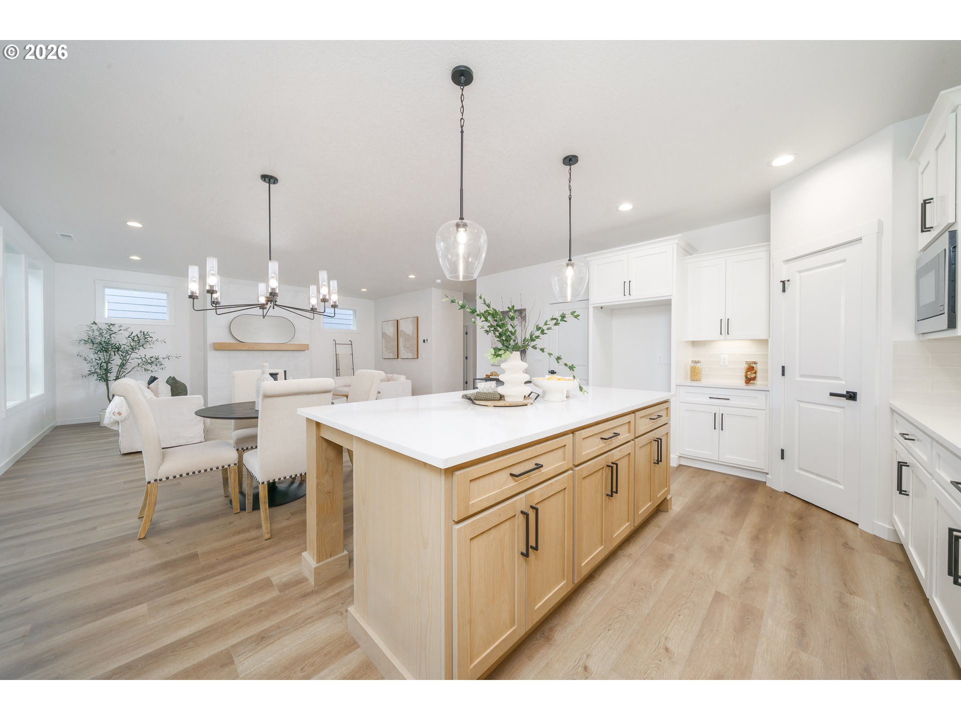 1908 Northwest 21st Circle Battle Ground, WA 98604 - Photo 16 of 40 a large kitchen with kitchen island a stove a sink dishwasher and a dining table with wooden floor
