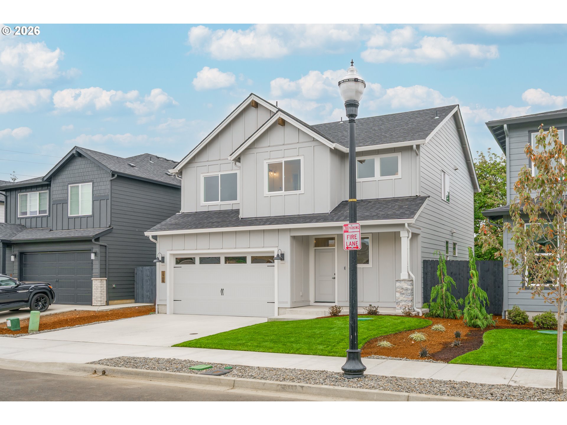 1908 Northwest 21st Circle Battle Ground, WA 98604 - Photo 3 of 40 a front view of a house with a yard and garage