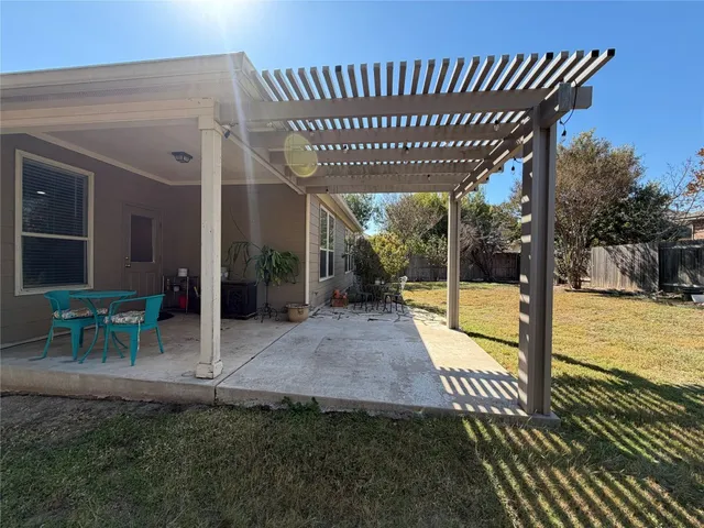 a view of a house with backyard and sitting area