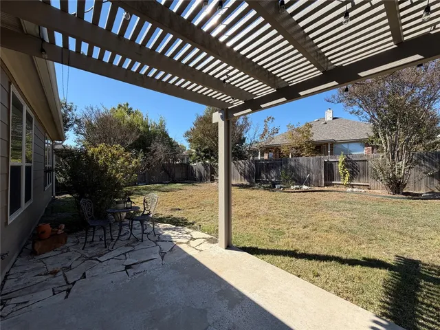 a view of a house with backyard porch and sitting area