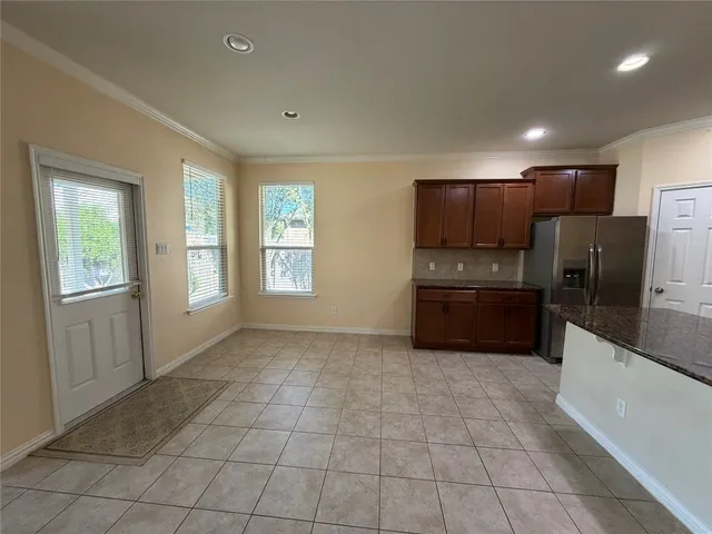 a kitchen with stainless steel appliances a refrigerator and a stove top oven