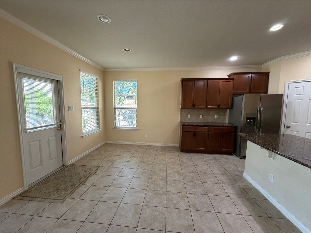 19904 Wearyall Hill Lane Pflugerville, TX 78660 - Photo 3 of 14 a kitchen with stainless steel appliances a refrigerator and a stove top oven