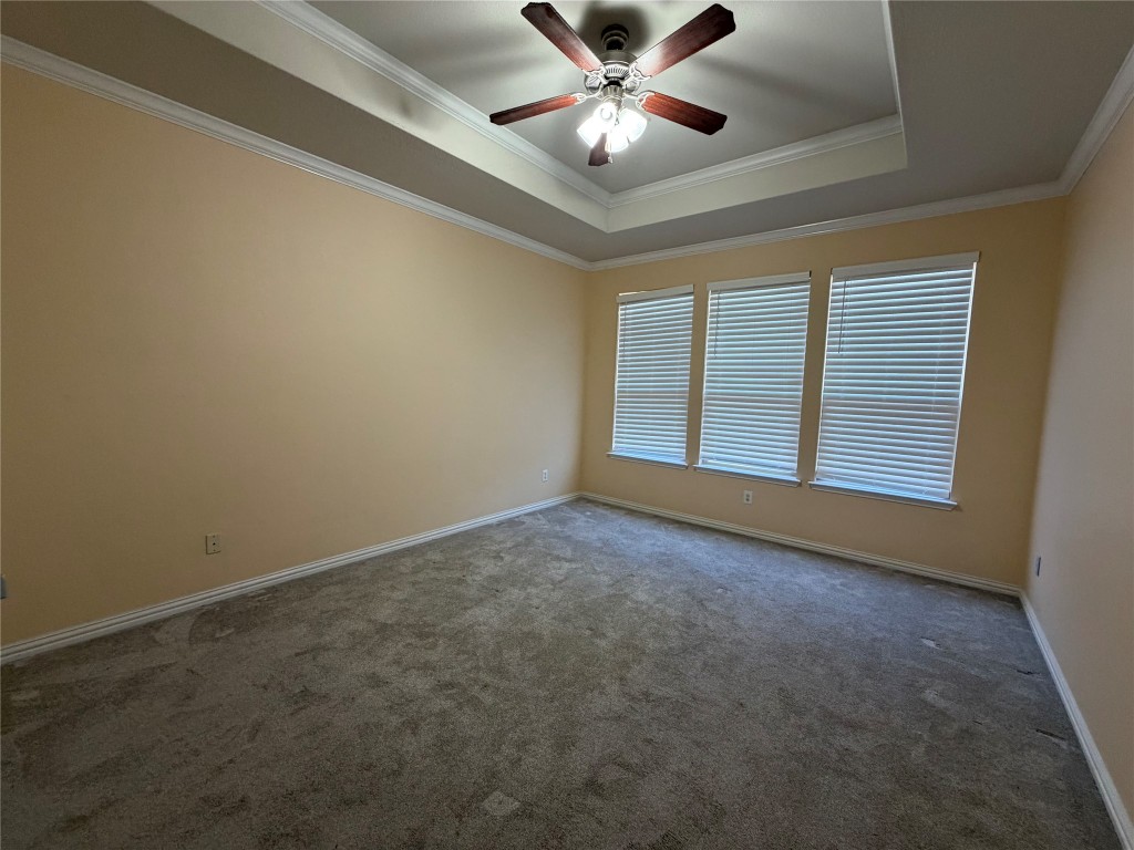 19904 Wearyall Hill Lane Pflugerville, TX 78660 - Photo 5 of 14 an empty room with chandelier fan and windows