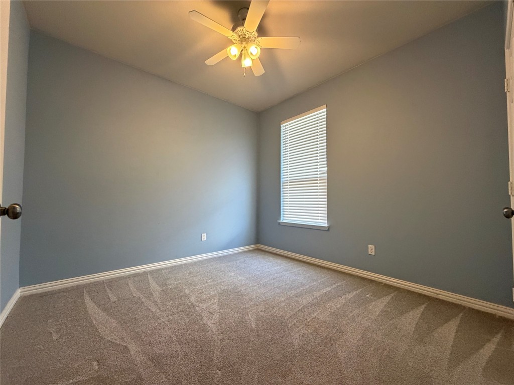 19904 Wearyall Hill Lane Pflugerville, TX 78660 - Photo 8 of 14 an empty room with windows and fan