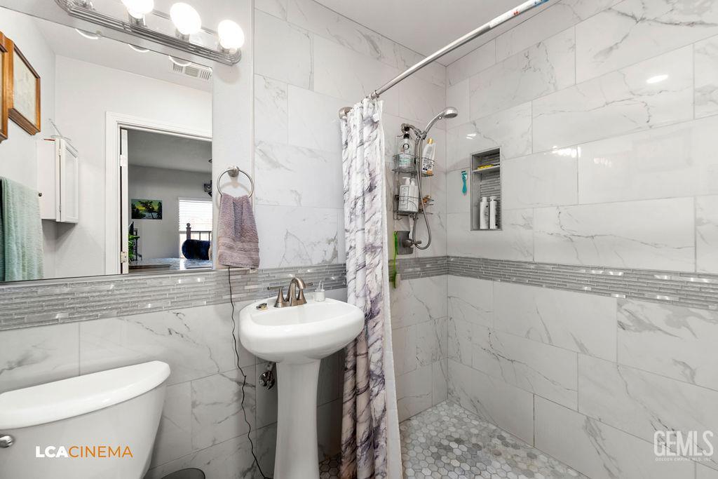 Undisclosed Address Wasco, CA 93280 - Photo 12 of 26 a bathroom with a sink toilet and shower