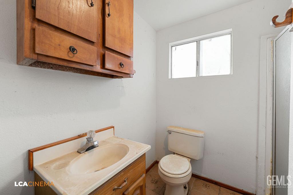 Undisclosed Address Wasco, CA 93280 - Photo 17 of 26 a bathroom with a sink a toilet and mirror