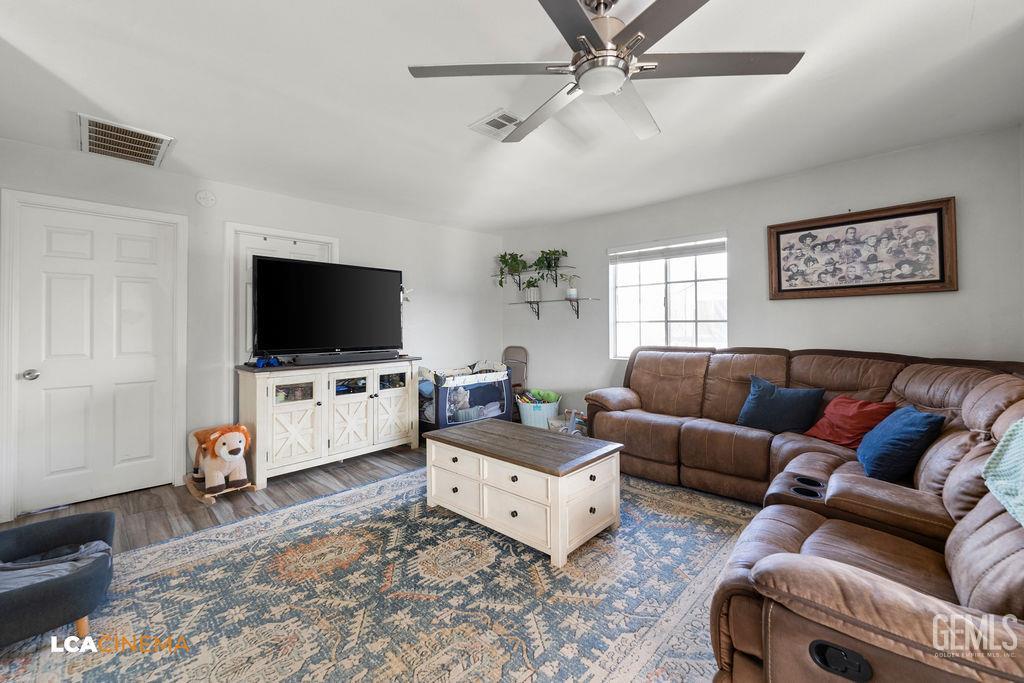 Undisclosed Address Wasco, CA 93280 - Photo 4 of 26 a living room with furniture and a flat screen tv