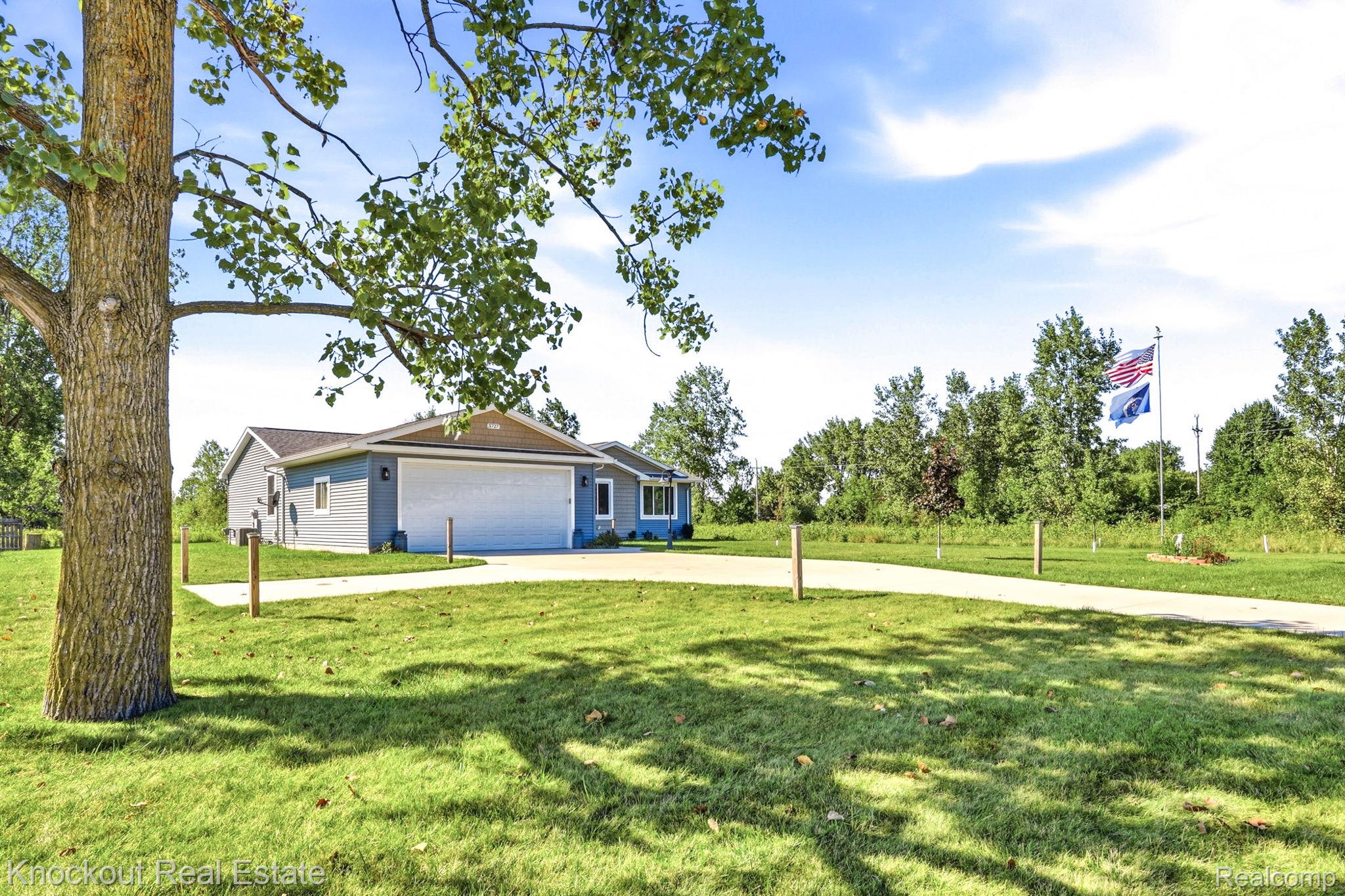 5727 Mackinaw Road Saginaw, MI 48604 - Photo 43 of 60 Ranch-style residence featuring light blue siding with white trim, an attached two-car garage, and a concrete driveway