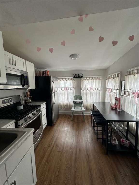 a kitchen with sink cabinets and wooden floor