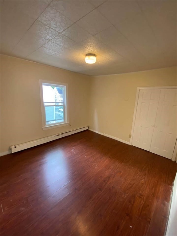 2 Prospect Street, Unit 2 Haverhill, MA 01832 - Photo 11 of 14 an empty room with wooden floor and windows