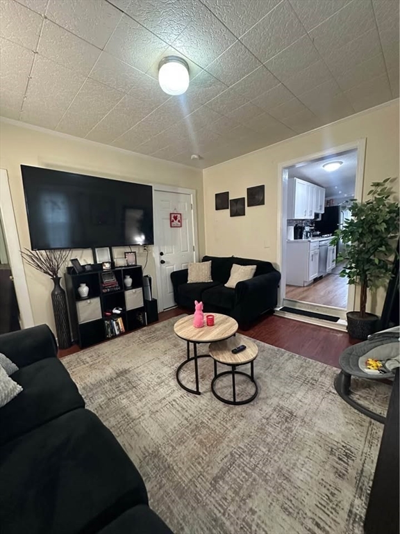 2 Prospect Street, Unit 2 Haverhill, MA 01832 - Photo 4 of 14 a living room with furniture and a flat screen tv