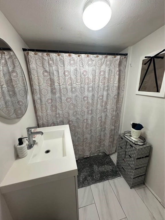 2 Prospect Street, Unit 2 Haverhill, MA 01832 - Photo 5 of 14 a bathroom with a sink and a mirror