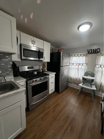 a kitchen with granite countertop a stove and a refrigerator