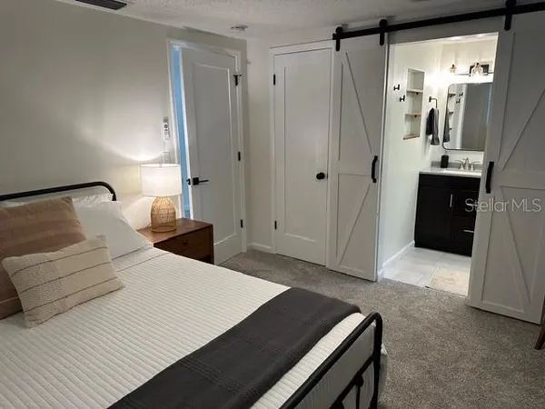 a bedroom with a bed and a walk in closet