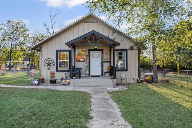 a front view of house with yard and outdoor seating