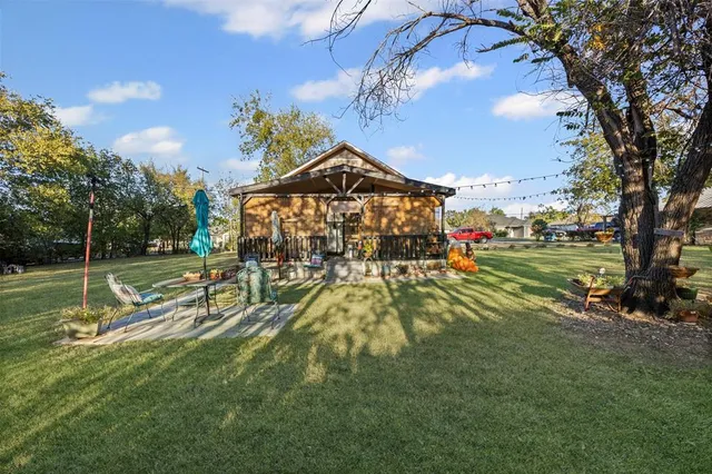 a view of yard with swimming pool and green space