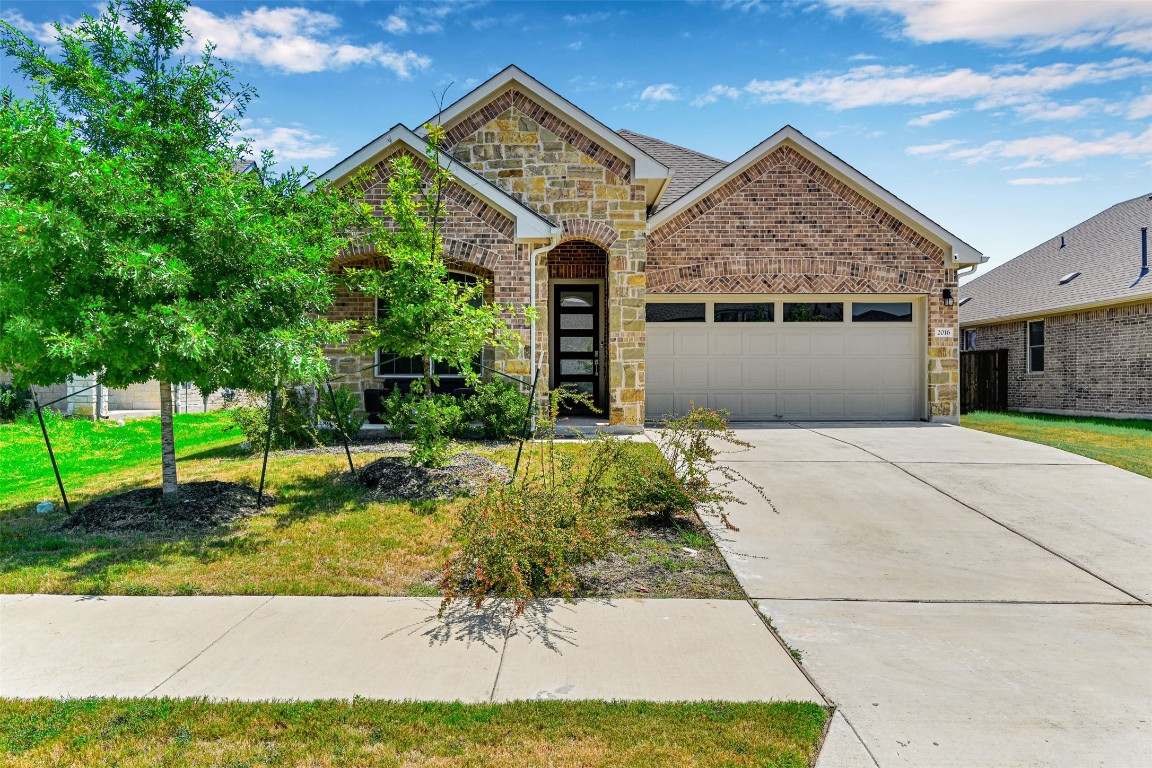 2016 Bobtail Pass Leander, TX 78641 - Photo 1 of 40 a front view of a house with a yard