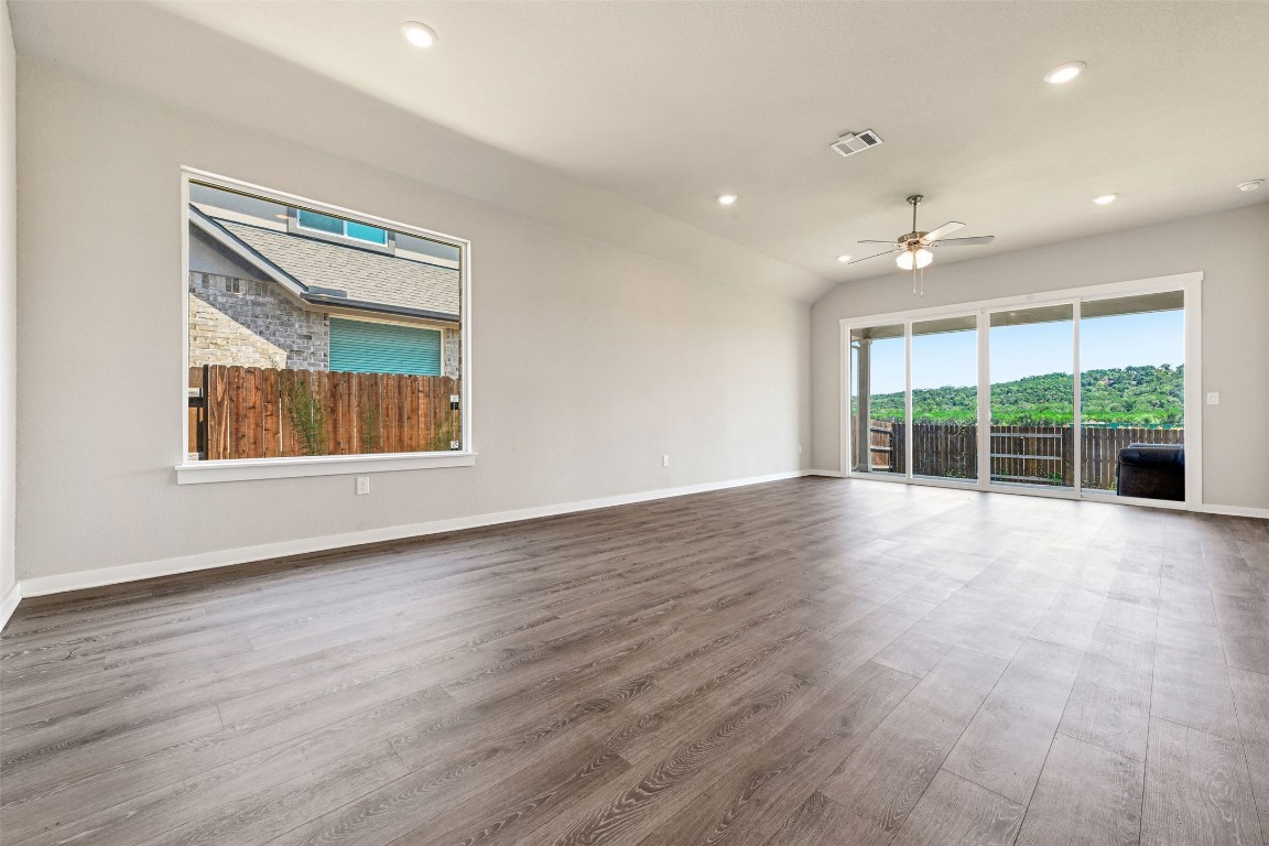 2016 Bobtail Pass Leander, TX 78641 - Photo 13 of 40 a view of an empty room with wooden floor and a window