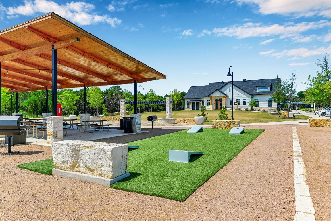 2016 Bobtail Pass Leander, TX 78641 - Photo 38 of 40 a view of a patio with a table and chairs under an umbrella