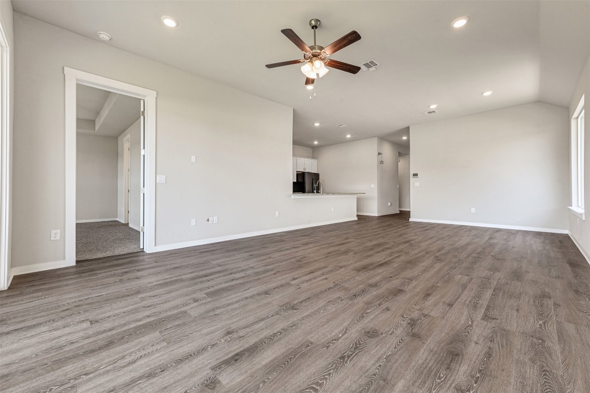 2016 Bobtail Pass Leander, TX 78641 - Photo 7 of 40 an empty room with wooden floor and a ceiling fan