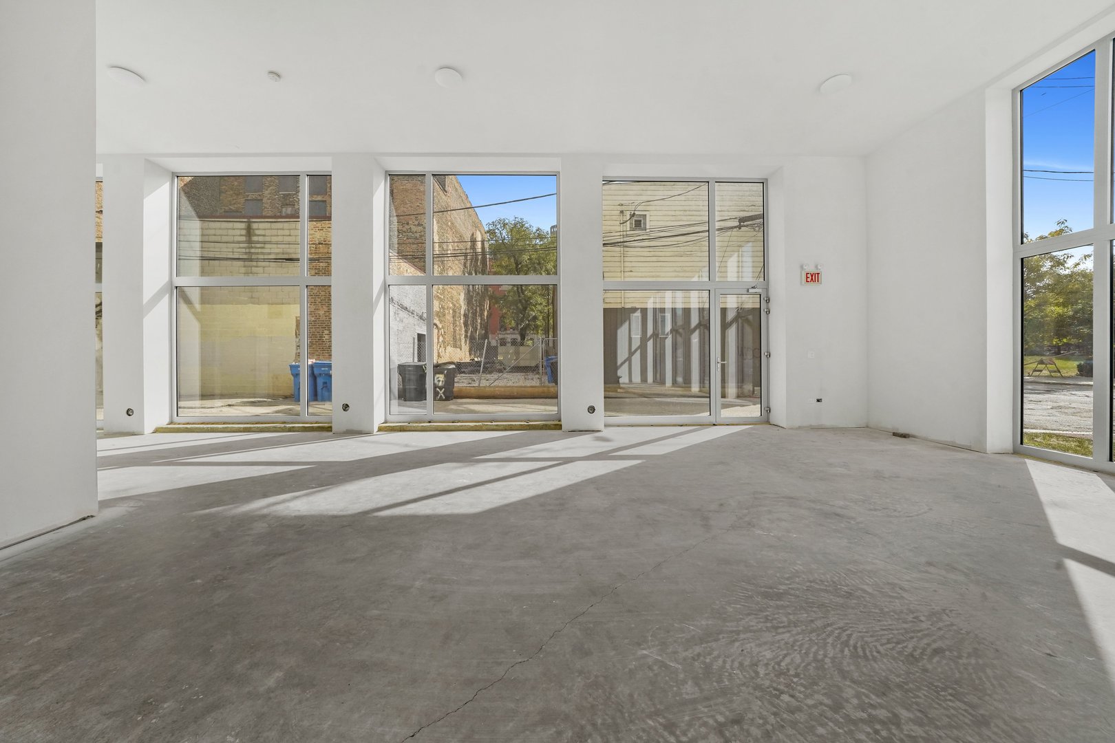 816 West Cullerton Street, Unit 1W Chicago, IL 60608 - Photo 13 of 34 a view of an empty room with wooden floor and windows