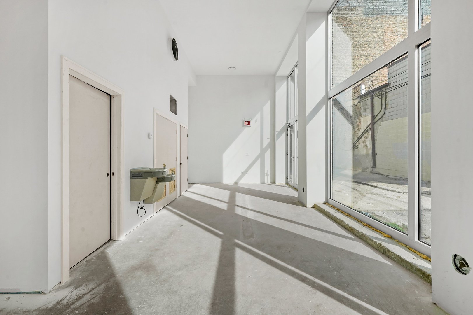 816 West Cullerton Street, Unit 1W Chicago, IL 60608 - Photo 15 of 34 a view of staircase with white walls and glass door