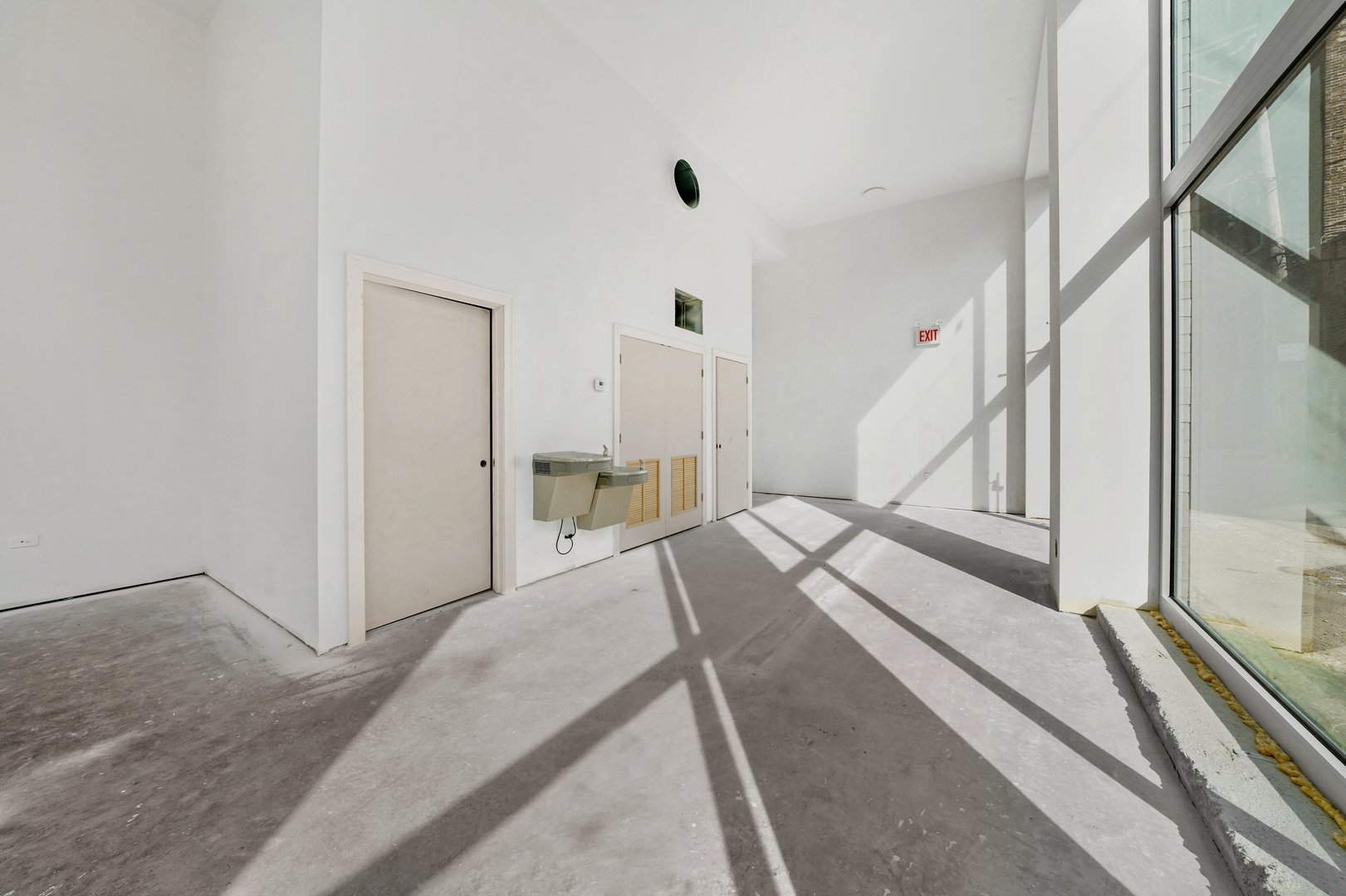 816 West Cullerton Street, Unit 1W Chicago, IL 60608 - Photo 16 of 34 a bedroom with a bed and a large mirror next to a window