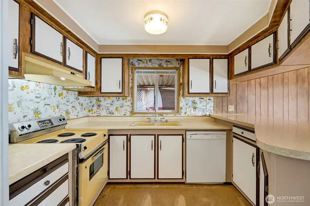 a kitchen with stainless steel appliances granite countertop a stove and a sink
