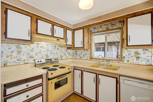 a view of a kitchen with a sink and a stove top oven