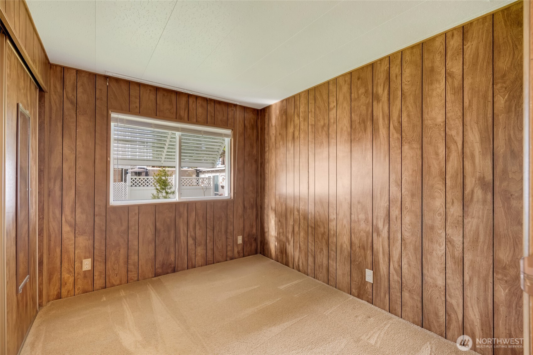 920 Maple Street, Unit 18 Sedro-Woolley, WA 98284 - Photo 21 of 32 a view of an empty room with wooden walls