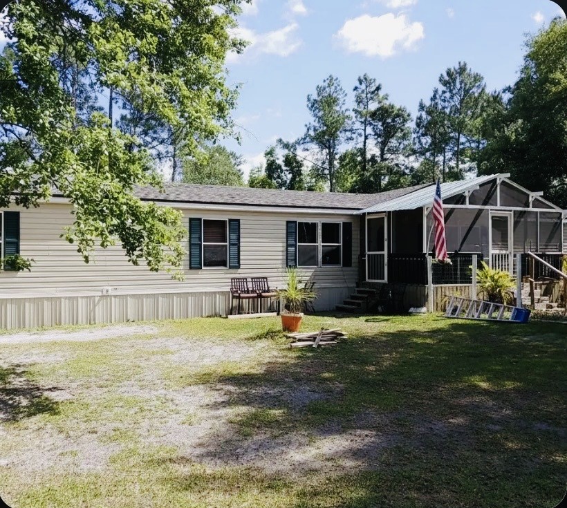 a view of a house with backyard porch and sitting area