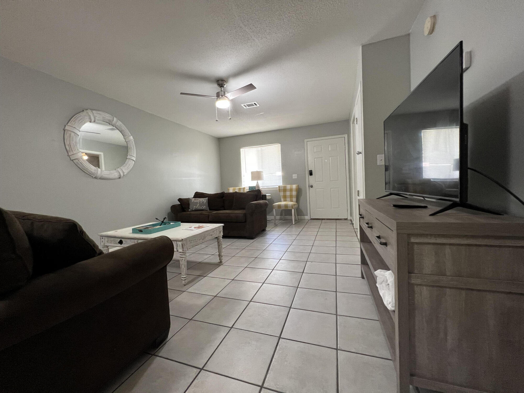 24 Blenheim Lane, Unit 7 Santa Rosa Beach, FL 32459 - Photo 3 of 11 a living room with furniture and a flat screen tv