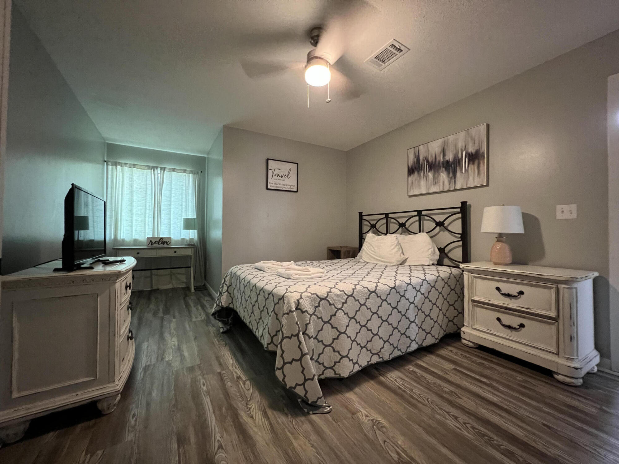 24 Blenheim Lane, Unit 7 Santa Rosa Beach, FL 32459 - Photo 8 of 11 a bedroom with a bed and a chandelier