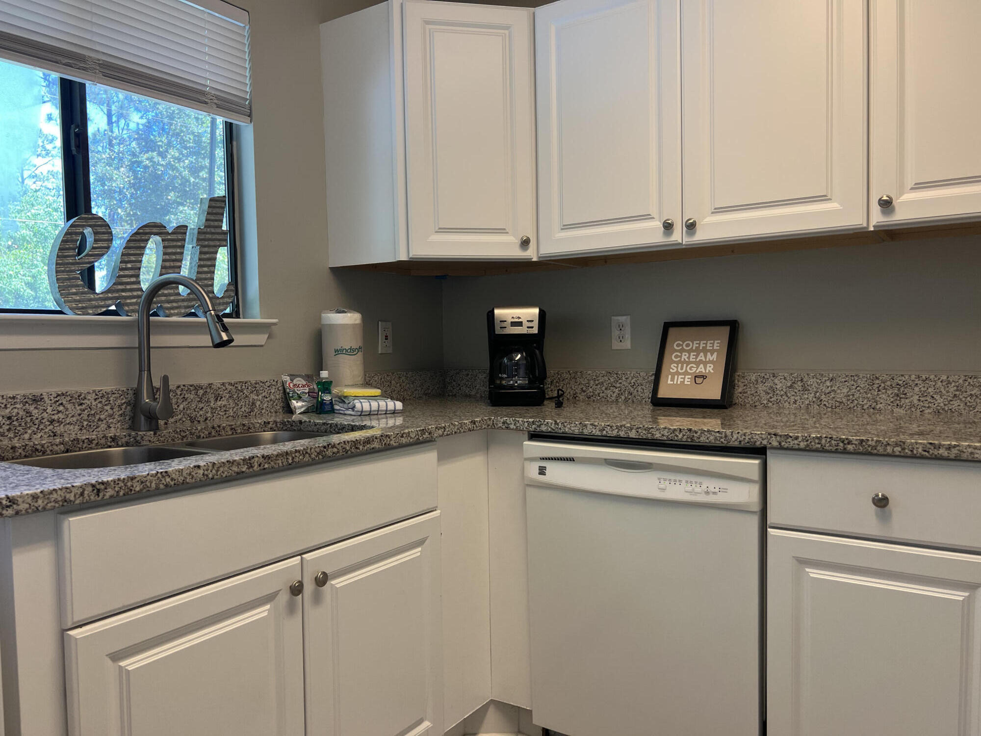 24 Blenheim Lane, Unit 7 Santa Rosa Beach, FL 32459 - Photo 10 of 11 a kitchen with granite countertop white cabinets and a sink