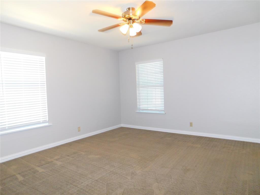 714 North Ruddell Street Denton, TX 76209 - Photo 13 of 20 an empty room with a window and a fan