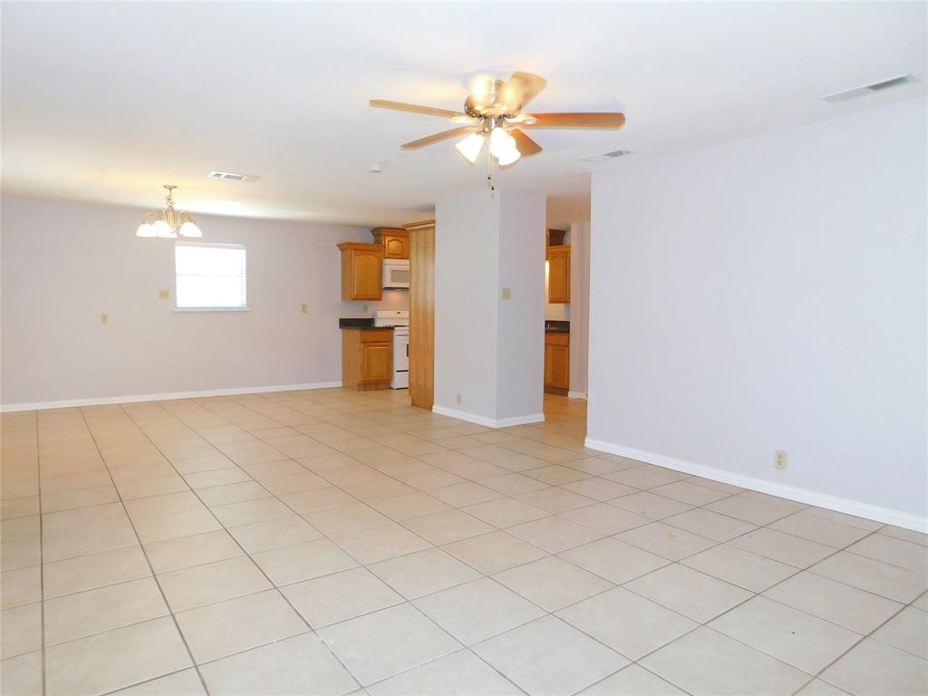 714 North Ruddell Street Denton, TX 76209 - Photo 5 of 20 an empty room with closet and a chandelier fan