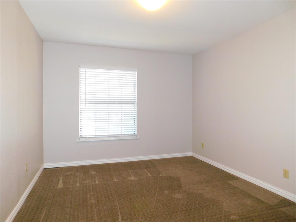 714 North Ruddell Street Denton, TX 76209 - Photo 8 of 20 an empty room with a window