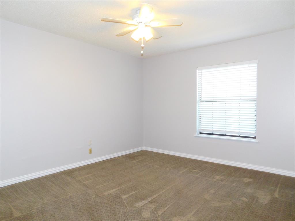 714 North Ruddell Street Denton, TX 76209 - Photo 10 of 20 an empty room with a window and a fan