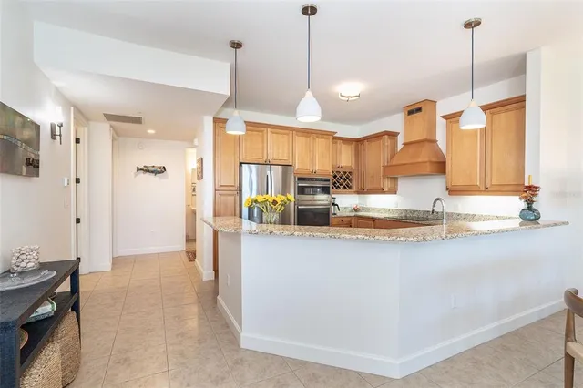 a kitchen with granite countertop stainless steel appliances sink and cabinets