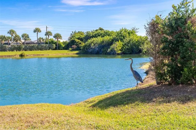 a swimming pool with outdoor seating and yard