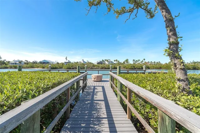 a view of swimming pool with lounge chair and dinning table under an umbrella