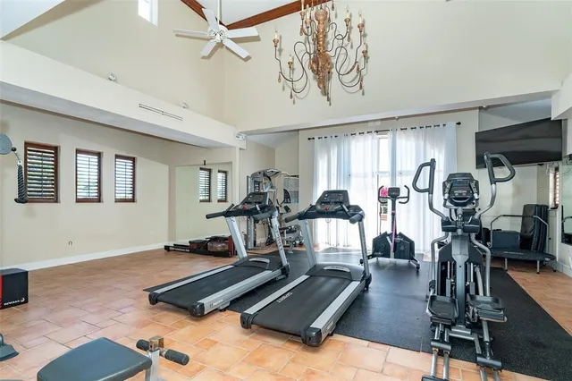 a view of a street with a building and palm trees