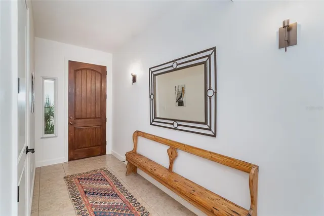 a bedroom with bed and a large mirror