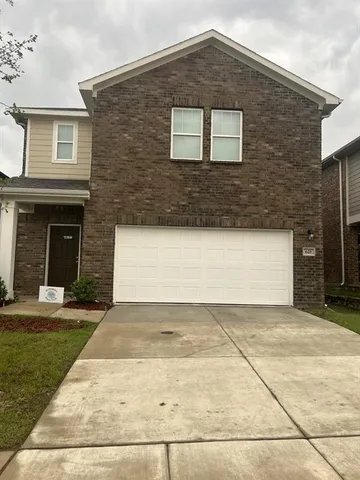 a front view of a house with yard